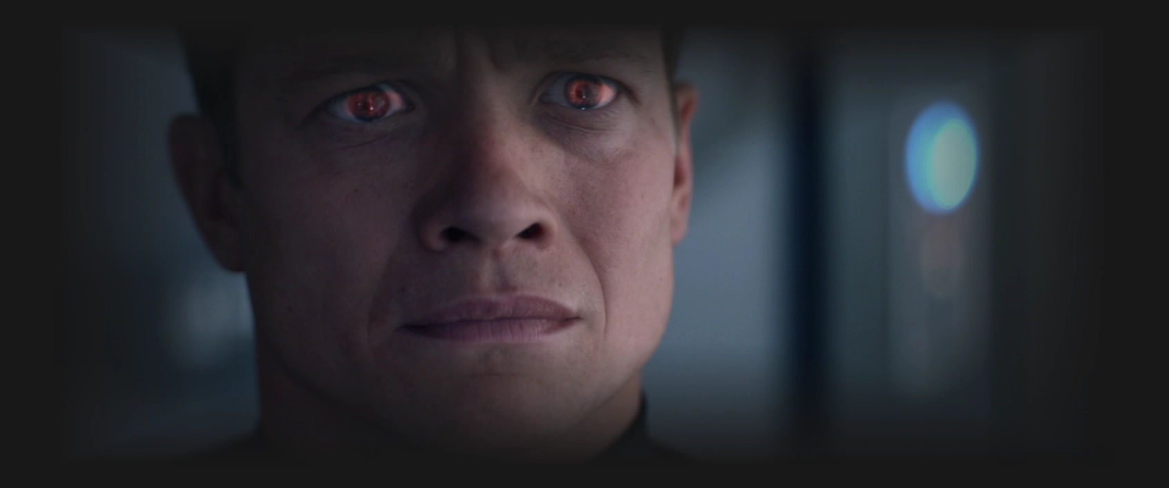 Jack Crusher looking concerned as a reflection of red light shines in his eyes