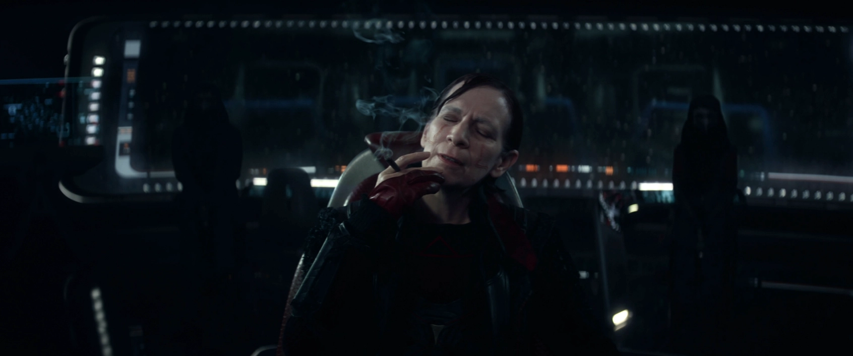 Vadic smoking a cigarette on the Titan bridge with two of her henchmen standing guard behind her