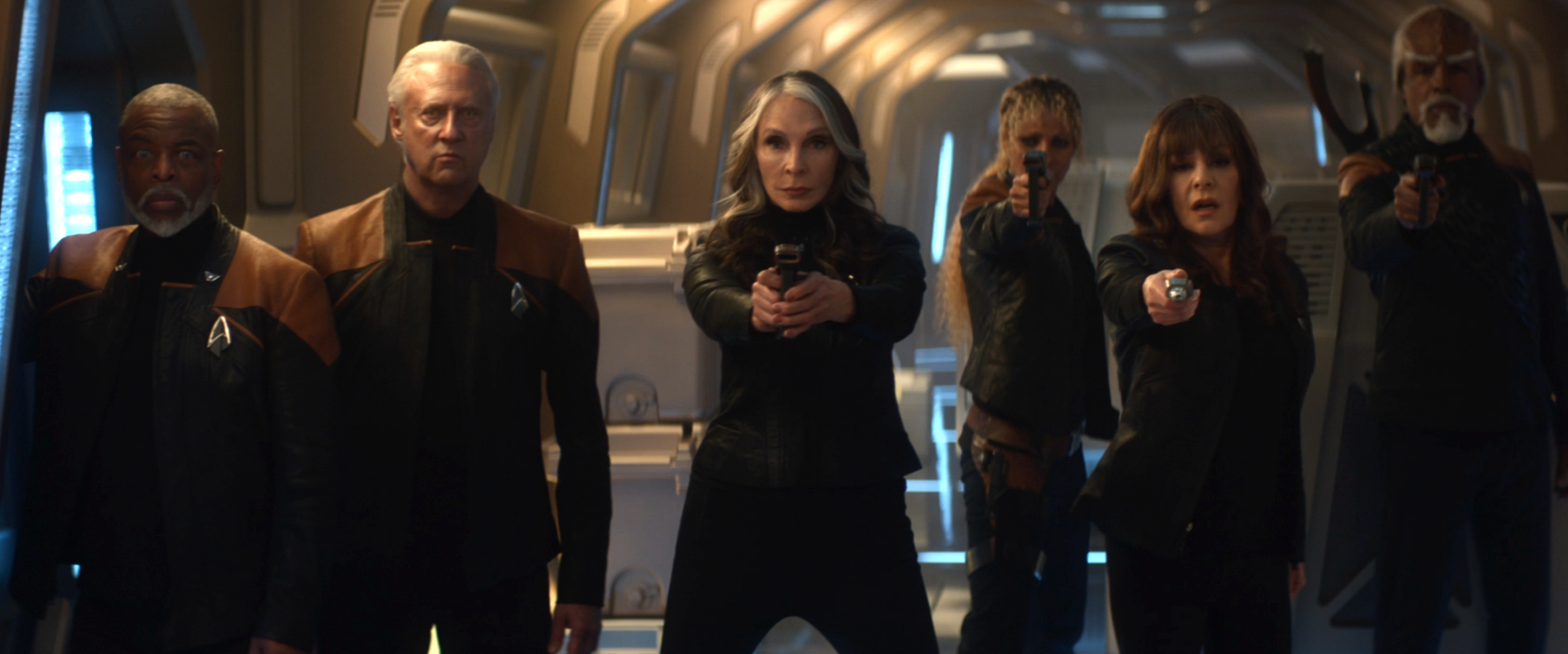 Crusher, Raffi, Troi, and Worf pointing phasers at the POV camera while Geordi and Data observe