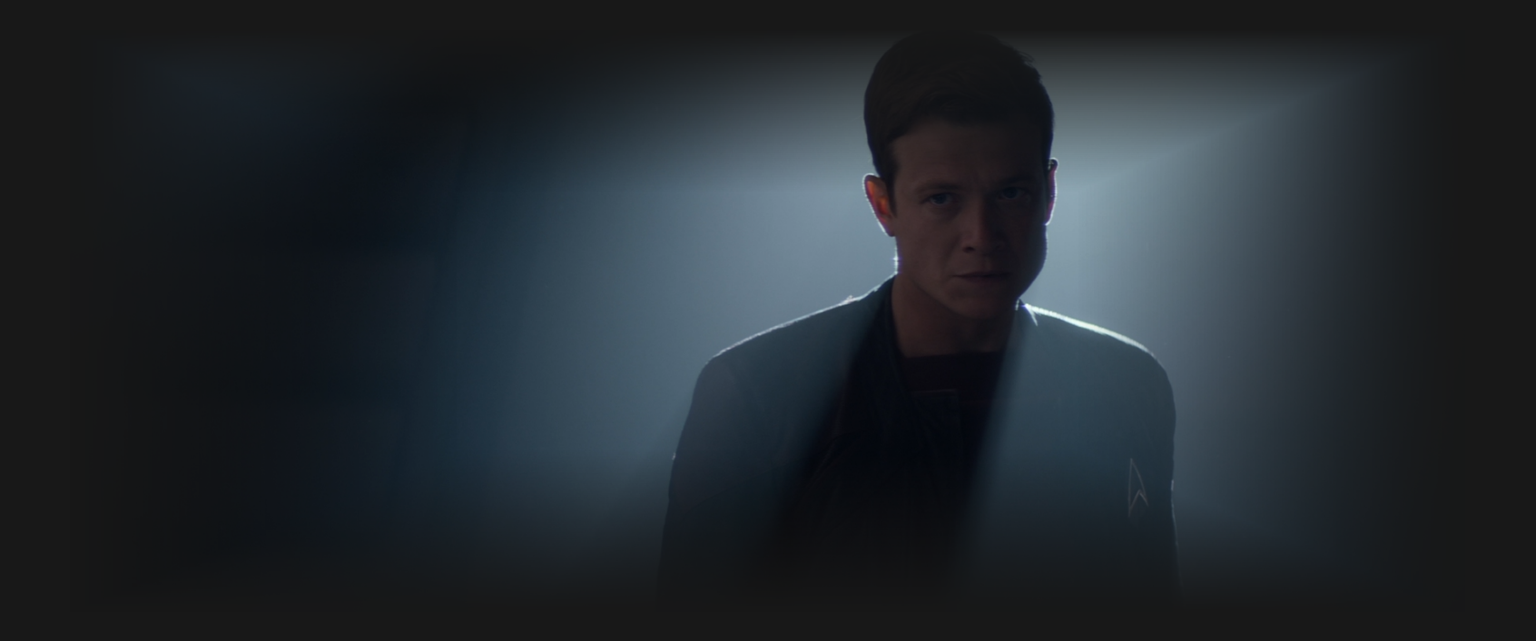 Jack Crusher, silhouetted by a smokey light behind him