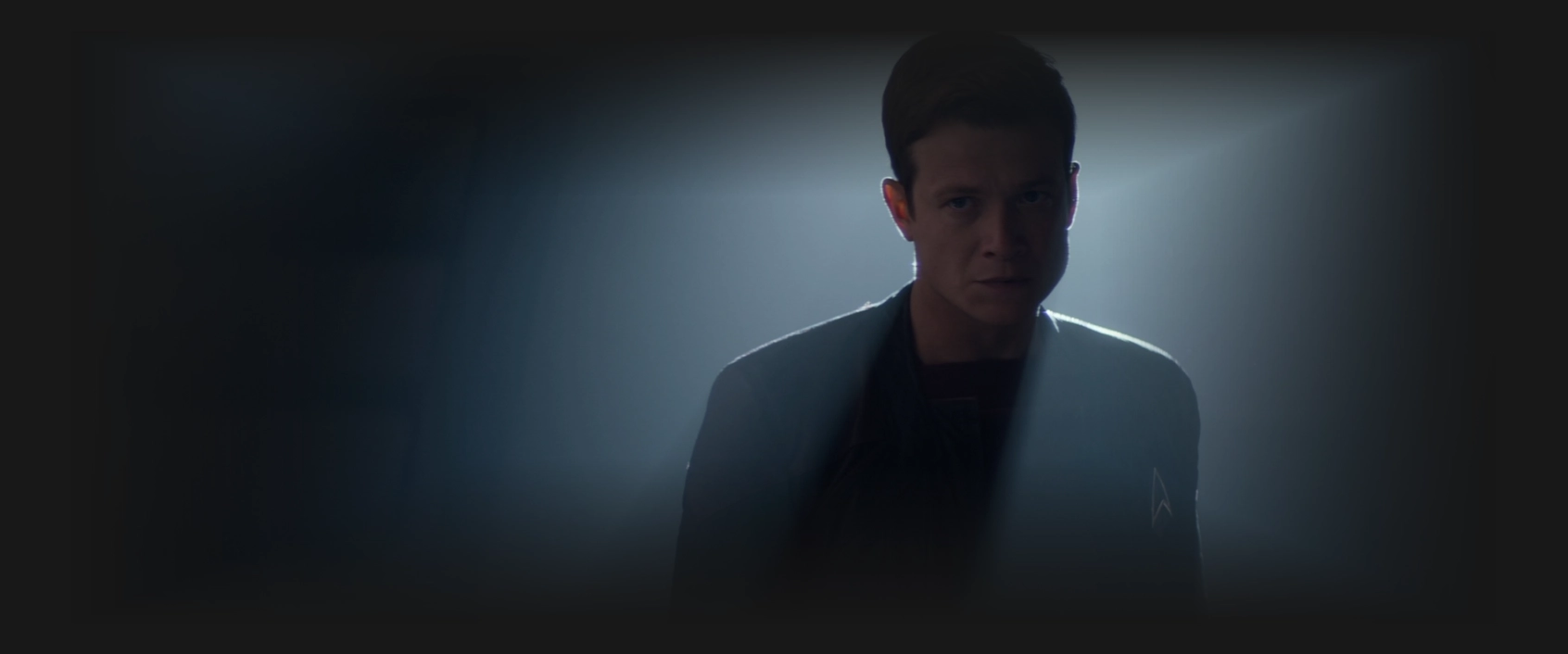 Jack Crusher, silhouetted by a smokey light behind him
