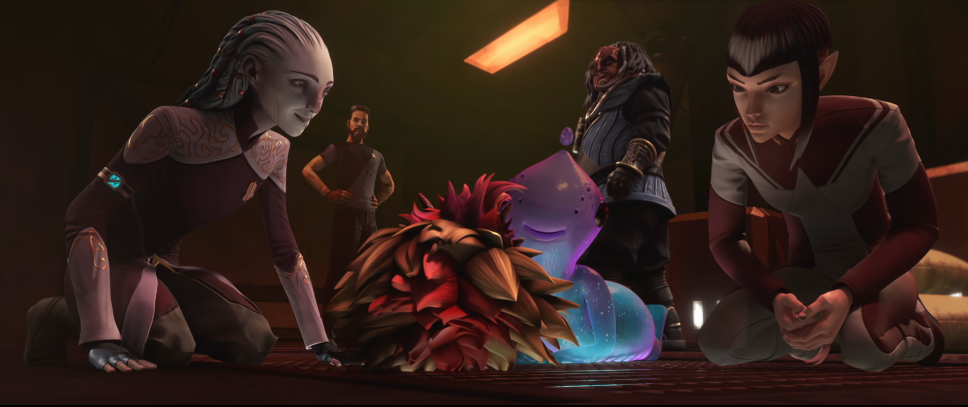 Gwyn, Maj'el, and Murf doting over a tribble-brikar hybrid