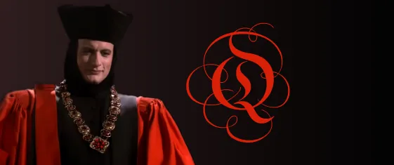 Q, wearing his judge's robes