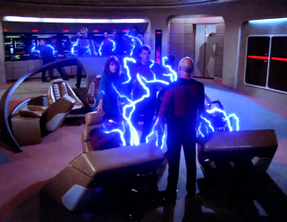 Picard standing at the front of the bridge while blue-colored lightning incapacitates the rest of the crew