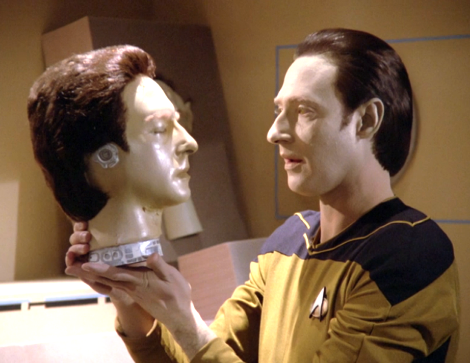 Data holding up an android head identical to his own