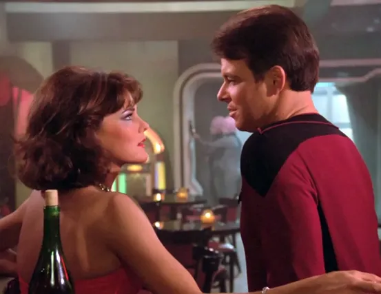 Riker talking to the holographic 'Minuet' while the Bynars work on the computer in the background