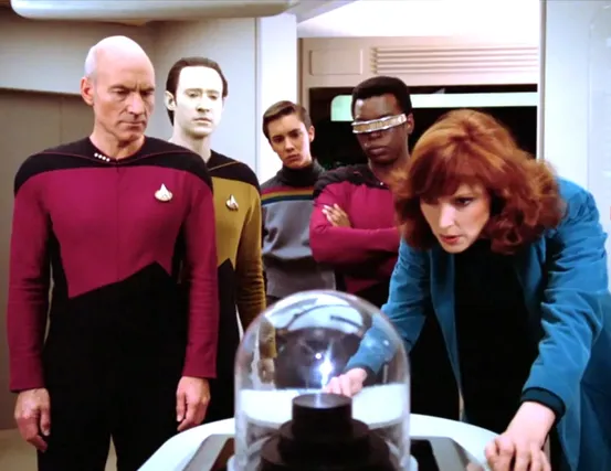 Picard, Data, Wesley, La Forge, and Crusher observing a new life form in the science lab