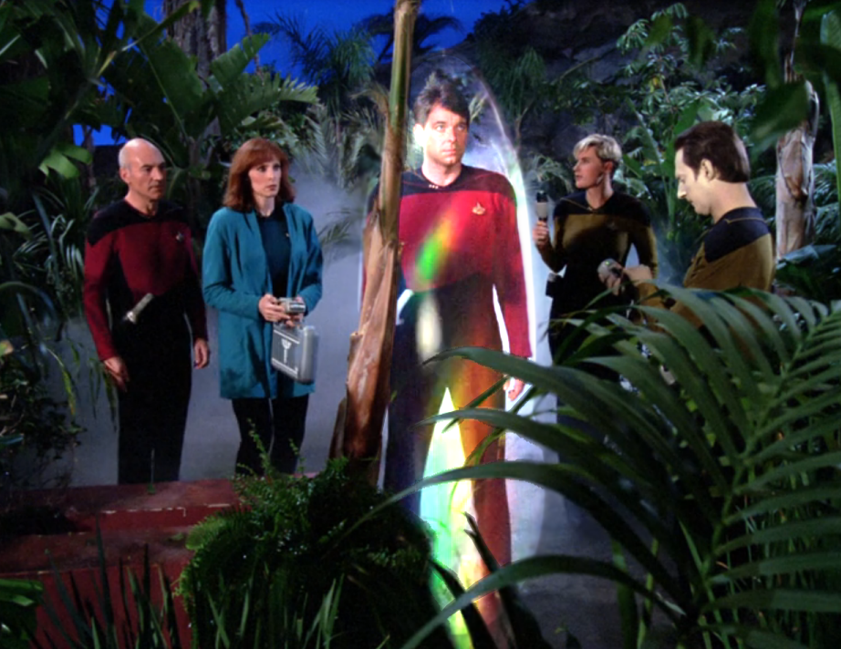 Picard, Crusher, Yar, and Data analyzing Riker, who has been trapped in a force field of some kind