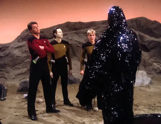 Riker, Data, and Yar confronting Armus, a life-form that appears like black tar