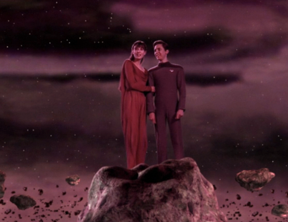 Wesley and young woman enjoying an asteroid belt on the holodeck