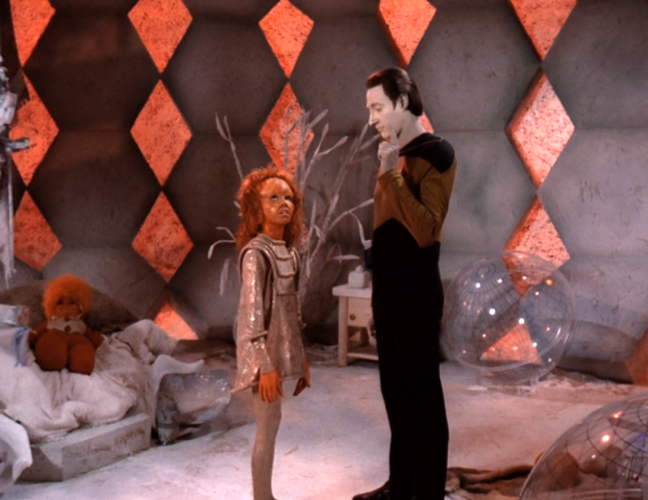 Data and a young girl speaking in her room