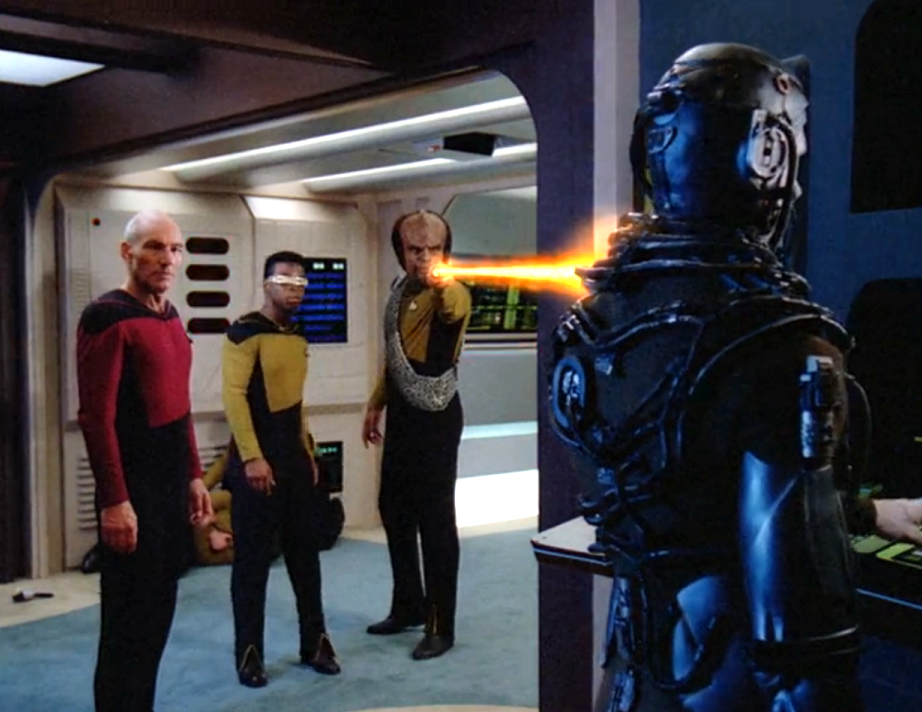 Worf firing his phaser at a Borg in Engineering