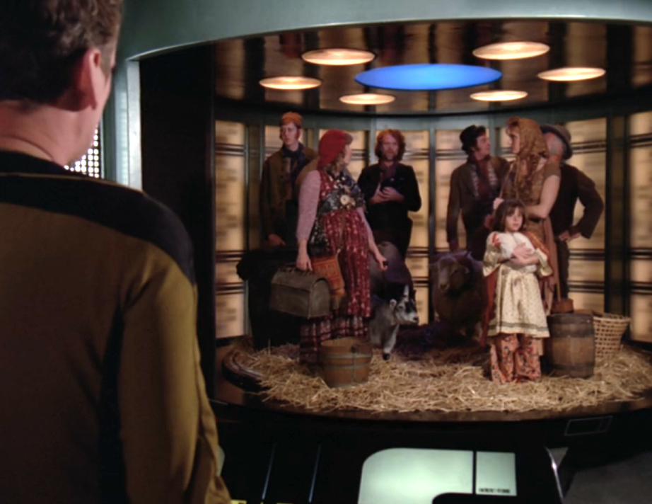 Seven people, some livestock, and a mound of hay on the transporter pad