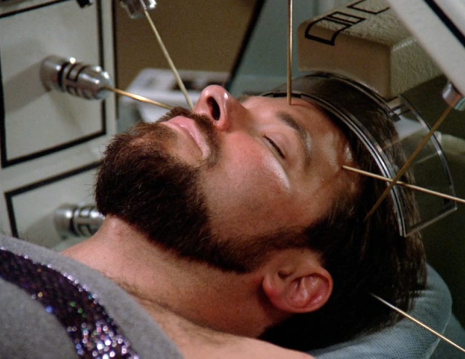Riker, on a medical biobed, with medical devices probing his brain