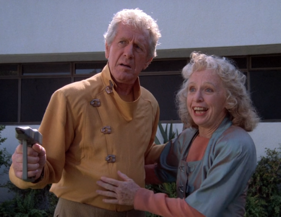 Rishon Uxbridge excitedly welcoming guests while Kevin Uxbridge holds them at gunpoint