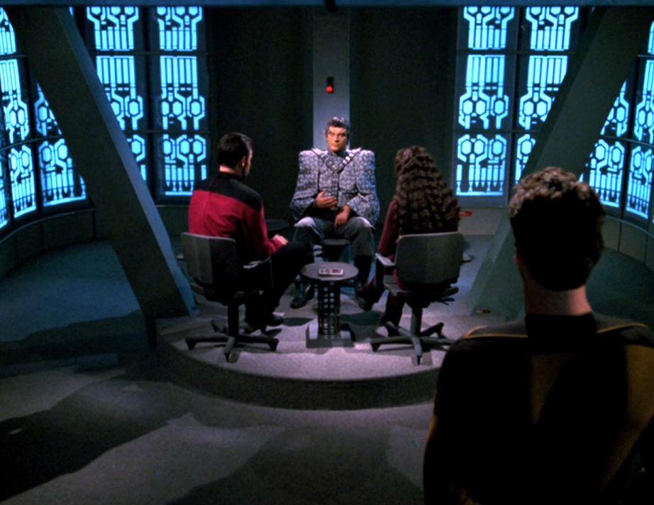 Riker and Troi interrogating a Romulan