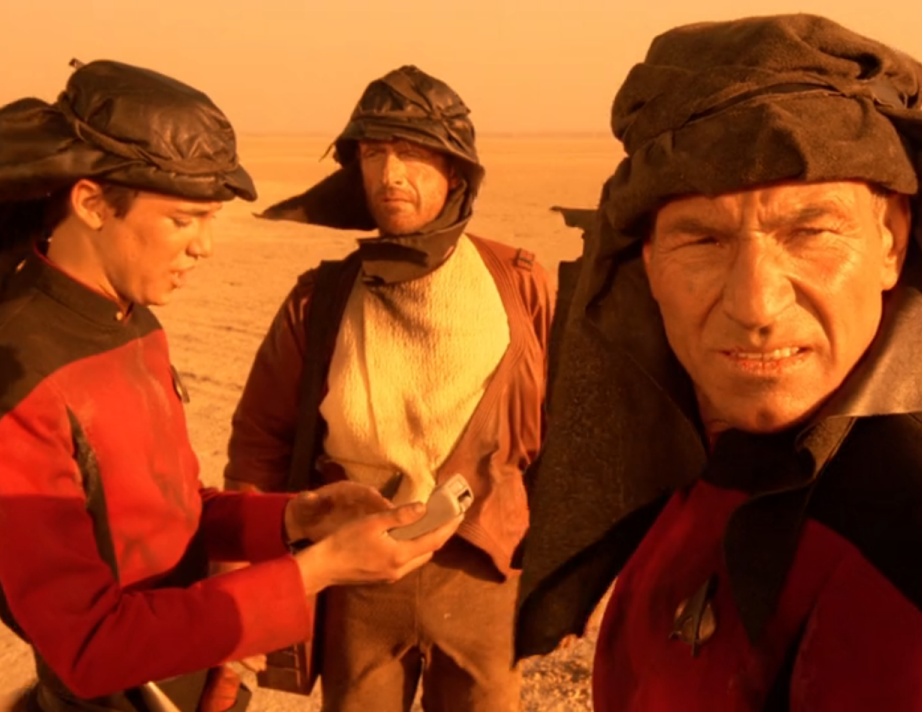 Picard, Wesley, and a third man on an arid plain