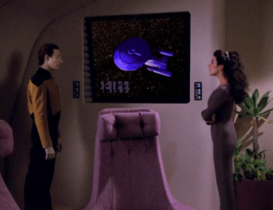 Troi and Data viewing a schematic of the two-dimensional beings on a viewscreen