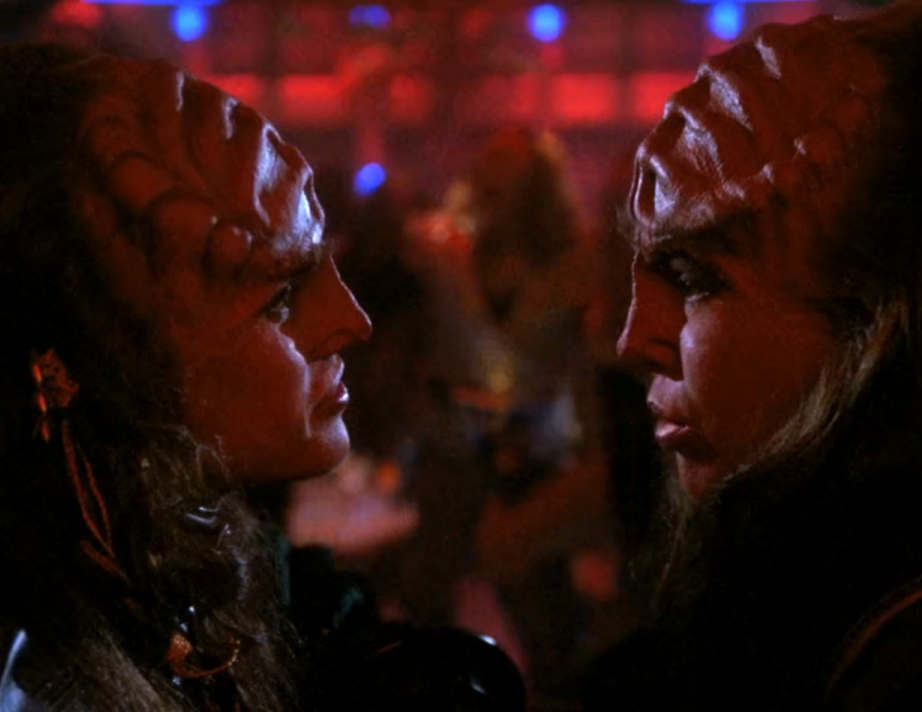 Lursa and B'Etor having a hushed conversation about Worf