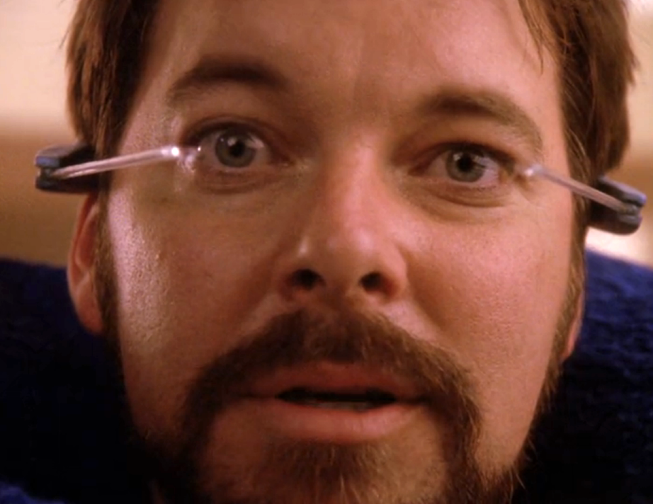 Riker wearing a strange headset device