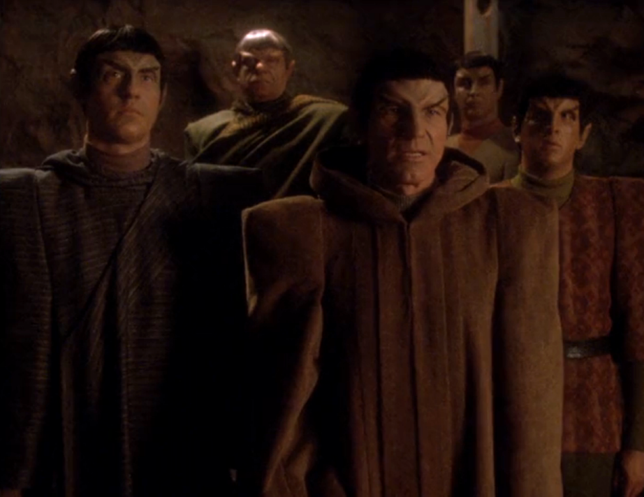 Picard, disguised as a Romulan, in a cavern with other Romulans