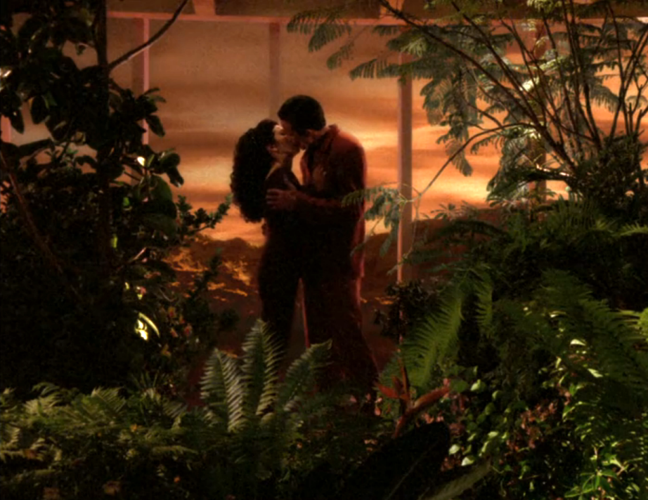 Troi and a man kissing