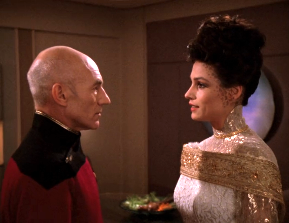 Picard, in a dress uniform, speaking with Kamala