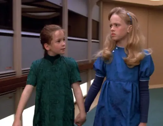 A young Clara Sutter holding hands with her best friend, Isabella