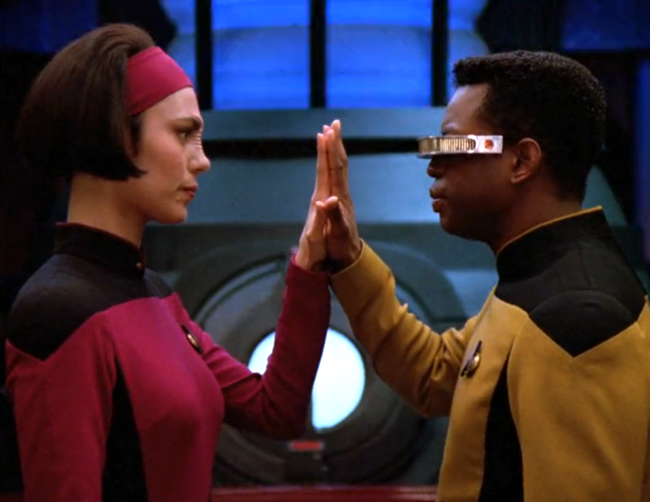 Ro and La Forge pressing their palms together to confirm that they are real