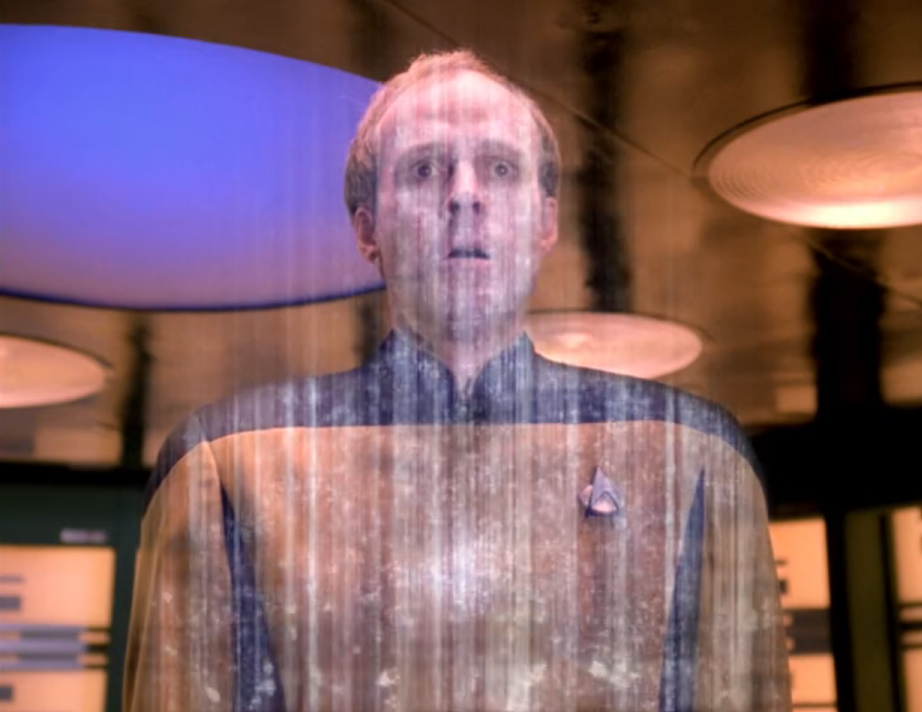 Barclay looking surprised as he dematerializes on the transporter pad
