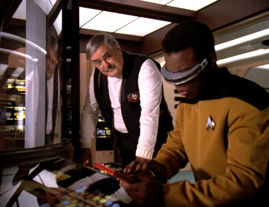 Montgomery Scott speaking with La Forge in main engineering