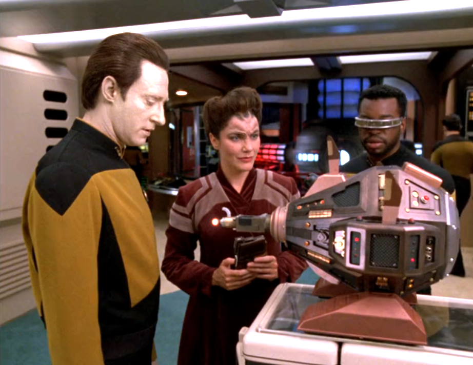 Data, La Forge, and another scientist examining an exocomp