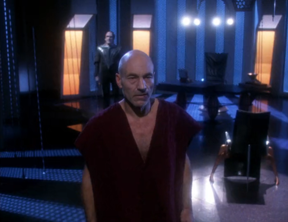 Picard and Gul Madred in the interrogation chamber with four lights overhead
