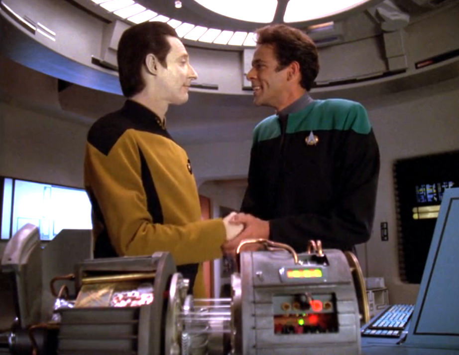 Data and Dr. Bashir shaking hands in the Enterprise's sickbay