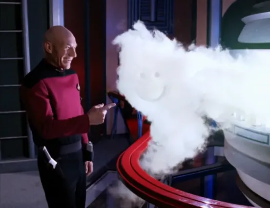 Picard laughing at a smiley face he has drawn in a static cloud of vapor