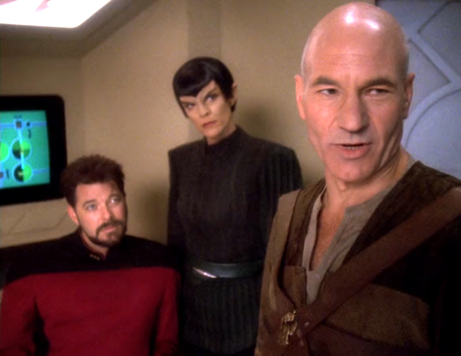 Picard, undercover in plainclothes, speaking while Riker and a Vulcan watch
