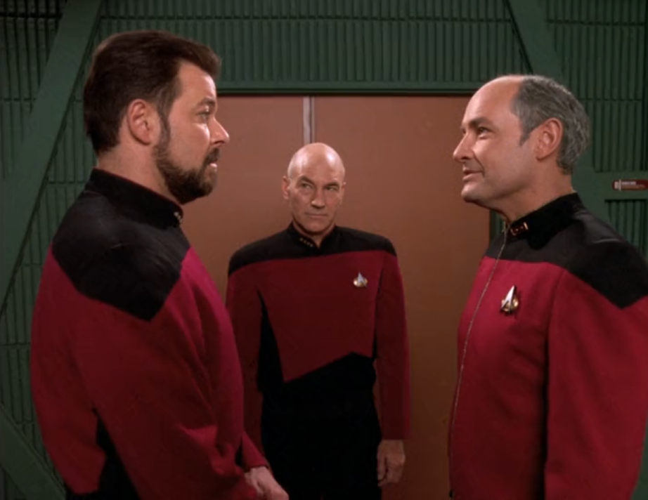 Riker greeting his former CO in the transporter room along with Captain Picard