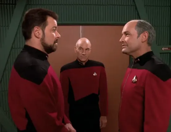 Riker greeting his former CO in the transporter room along with Captain Picard