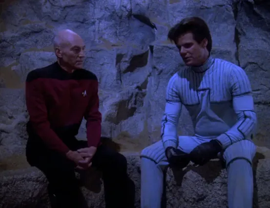 Picard and Jason Vigo having a conversation on a rock climbing ledge