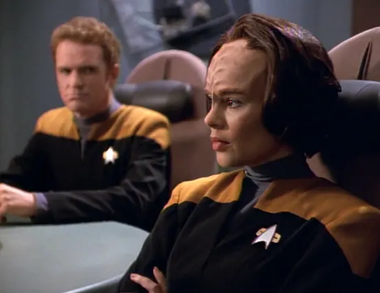Torres and Carey sitting at the conference table