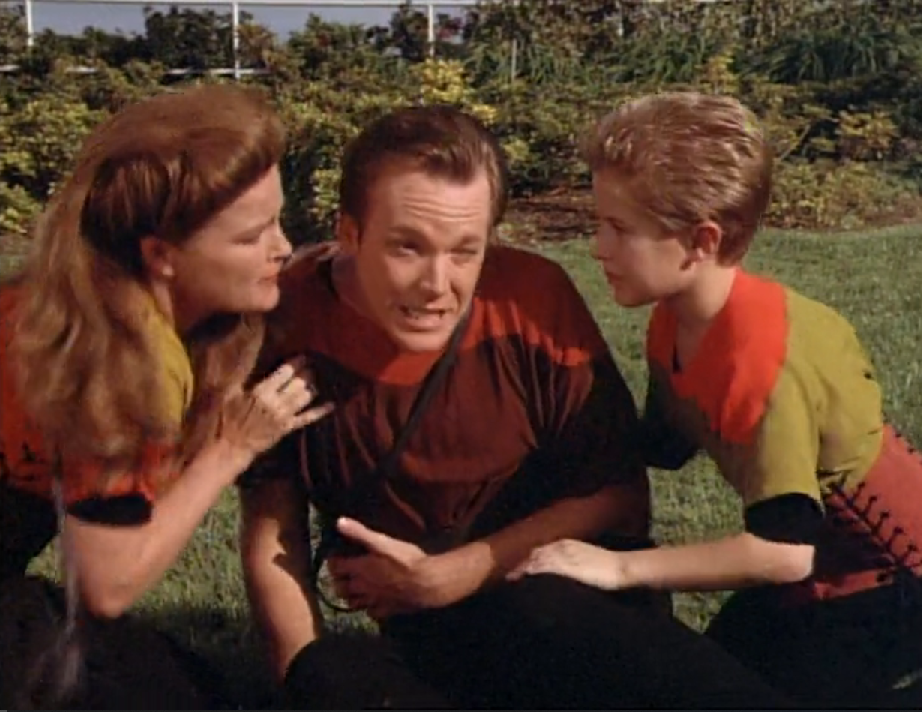Janeway and a young boy tend to an injured Paris