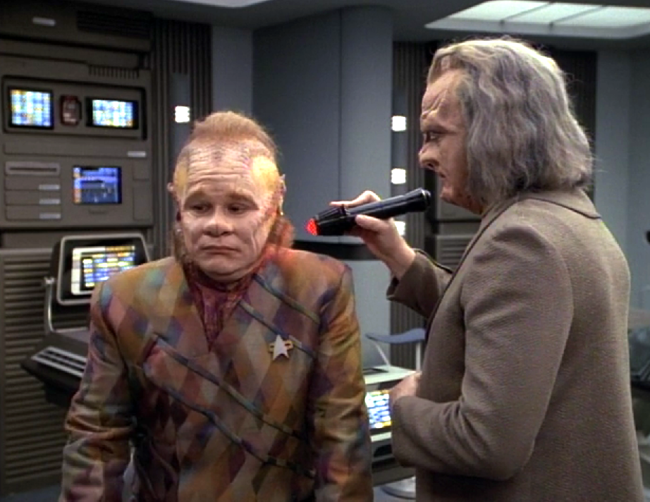 An alien scanning Neelix with a medical device