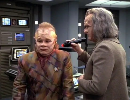 An alien scanning Neelix with a medical device