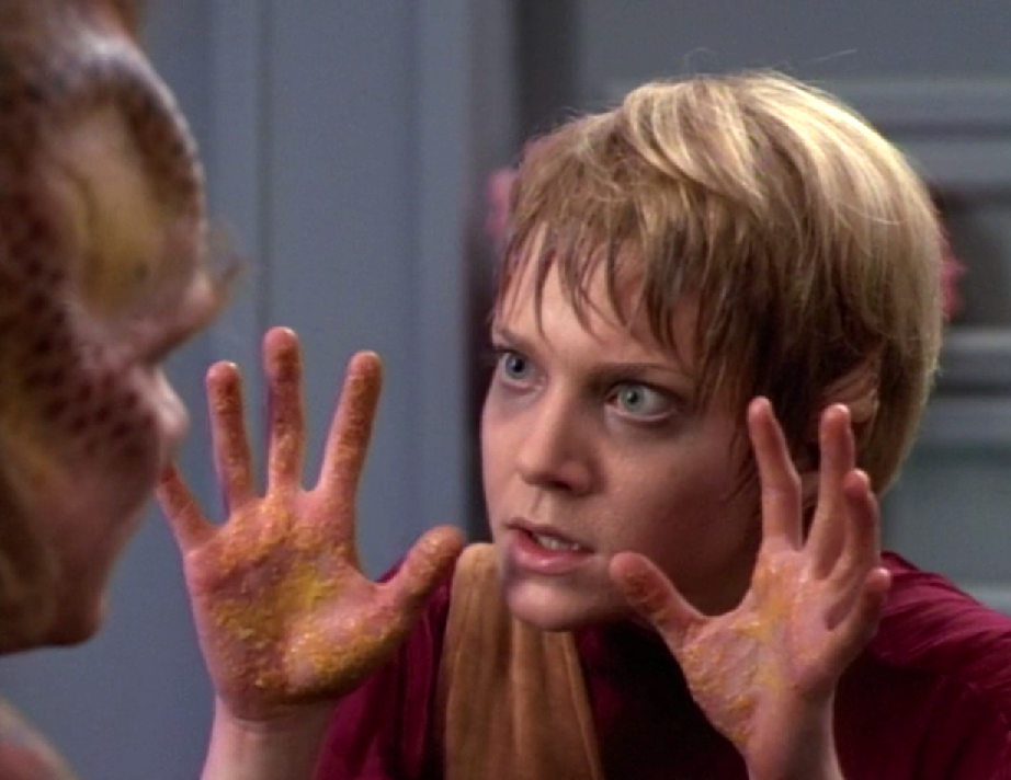 A sweaty Kes shows her hands to Neelix; they appear to be covered in a strange yellow substance
