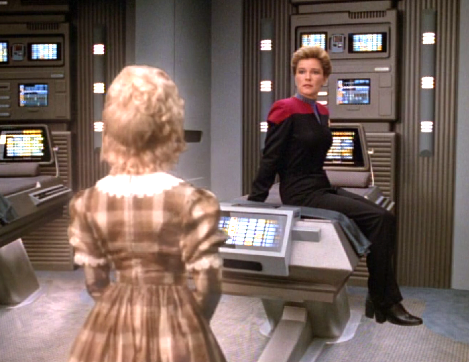 Janeway sits on a biobed in sickbay appearing shocked when a young Victorian girl from her holonovel appears before her