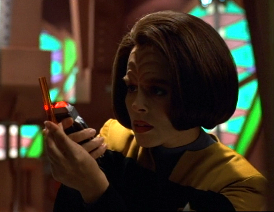 Torres scanning a data rod in a room of Cardassian design