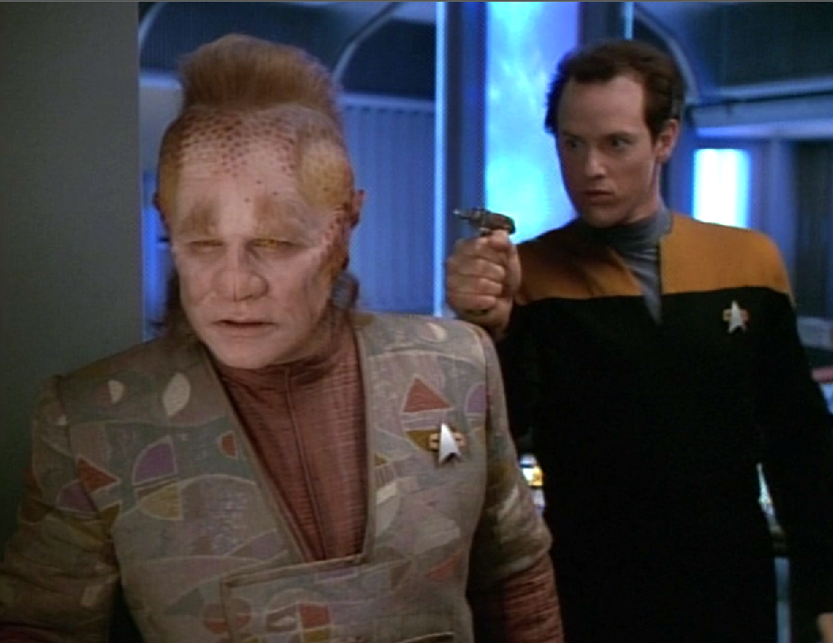 An engineer sneaking up behind Neelix about to attack him with a plasma torch