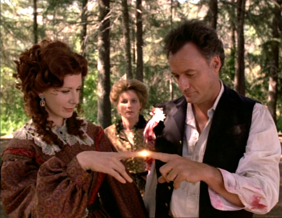 Q and a woman wearing civil war-era clothing touching the tips of their fingers together while Janeway observes