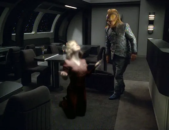Kes kneeling in the mess hall with the top half of her body glowing while a shocked Neelix watches