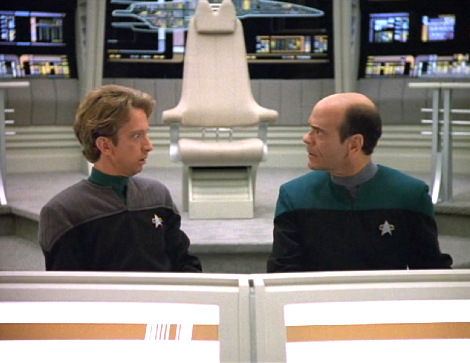 The Doctor and the EMH Mark 2 sitting at the helm of an unfamiliar bridge